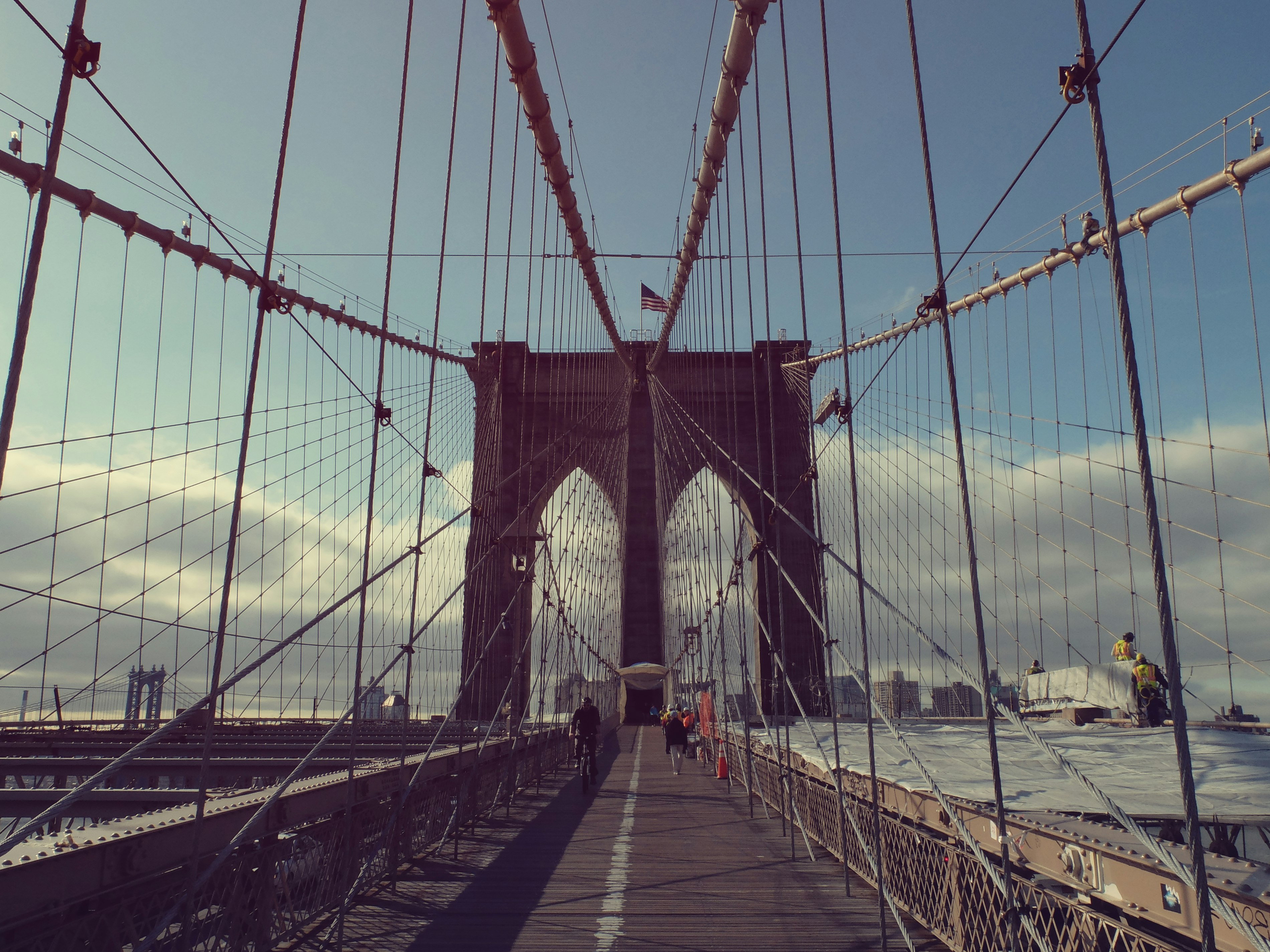 gray concrete bridge under white and blue sky